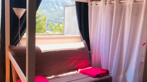 Etagenbett in einem Zimmer mit Fenster in der Unterkunft Chez So Orcieres in Orcières