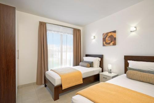a hotel room with two beds and a window at Melia Dunas Beach Resort & Spa - All Inclusive in Santa Maria