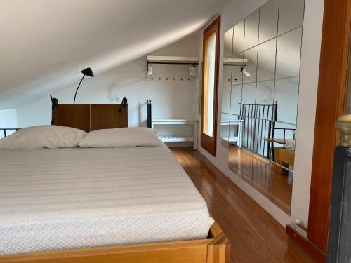 a bedroom with a large white bed in a room at Miniloft panoramico in Rio nellʼElba