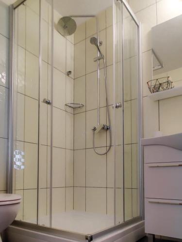 a shower with a glass door in a bathroom at Marios in Brela