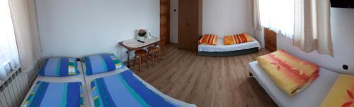 a small room with two beds and a table at Pod Tatarską Górą in Biały Dunajec