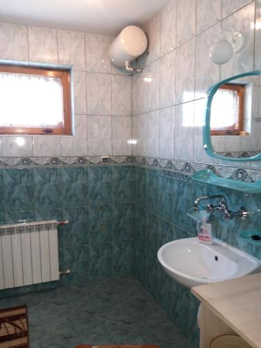 a bathroom with a sink and a mirror at Pod Tatarską Górą in Biały Dunajec