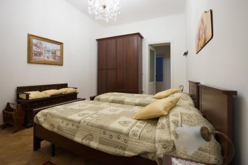 a bedroom with two beds and a chandelier at Antico Borgo Teresiano in Trieste