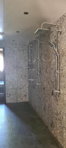 a room with a stone wall with racks on the wall at Toolse Puhkeküla in Toolse