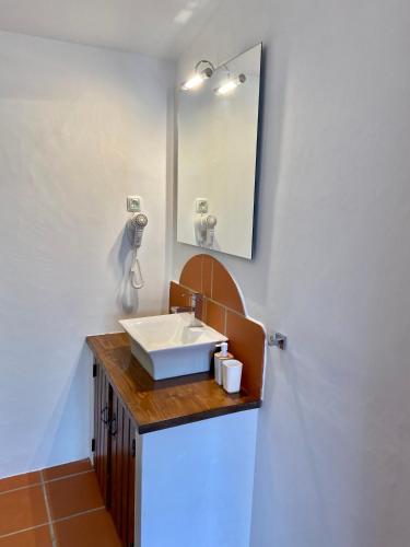 a bathroom with a sink and a mirror at Montes de Charme (AL 6288) in Avis