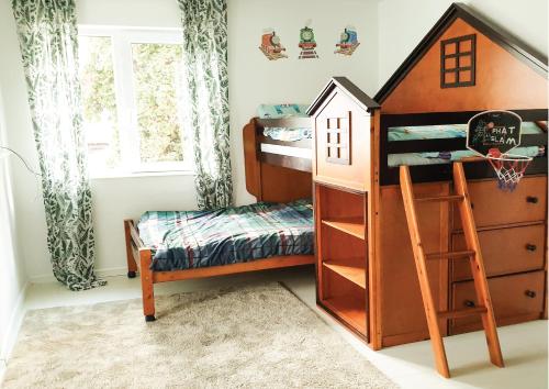 a childs bedroom with a bunk bed and a desk at La Cuib in Câmpulung Moldovenesc