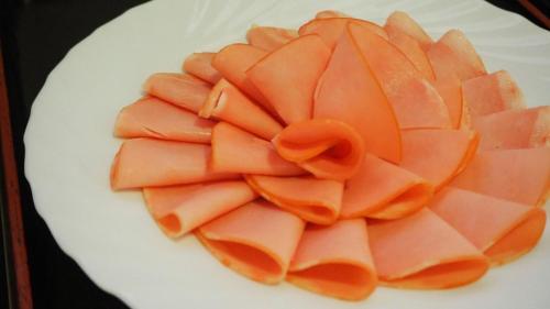 a white plate topped with orange cut up carrots at 大村ヤスダオーシャンホテル in Omura