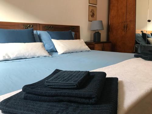 a bed with a black blanket on it at La casetta del nonno Giampi in Sesto Calende