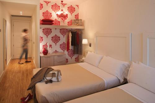 Postel nebo postele na pokoji v ubytování Le Rose Suite Hotel