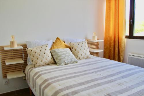 a bedroom with a large bed with a striped blanket at LE PALM - 1 ère ligne vue mer - Exceptionnel P2 cabine in La Grande-Motte