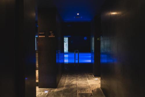 a dark hallway with blue lights in a room at Balneario Font Vella- Adults Only in Sant Hilari Sacalm