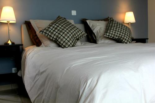 a large white bed with two pillows on it at B&B Laurus in Ieper