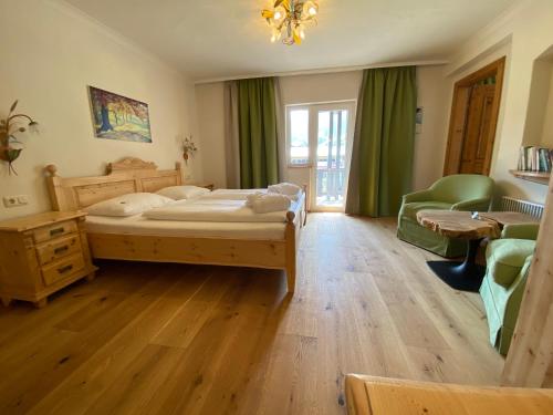a bedroom with a bed and a table and chairs at Stammhaus im Hotel Alpine Palace in Saalbach Hinterglemm