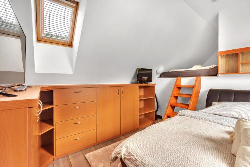 a bedroom with a bed and a desk and a bed at Rezidence Rokytnice in Rokytnice nad Jizerou