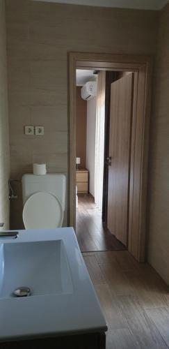 a bathroom with a white tub and a toilet at Garden Club Panzió in Balatonmáriafürdő