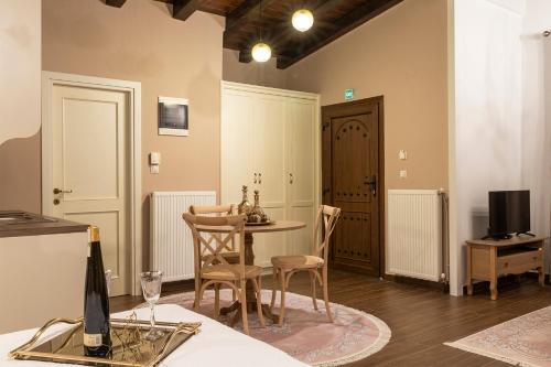 a living room with a table and chairs and a tv at Villa La Varik 3 in Litochoro