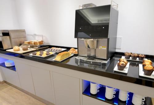 a kitchen with a counter with various pastries on plates at UVE Marcenado in Madrid