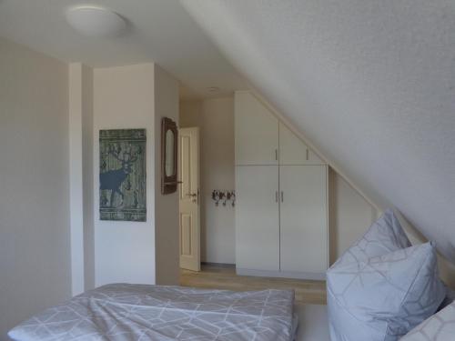 a bedroom with a bed and a staircase at Ankommen-Durchatmen in Boren