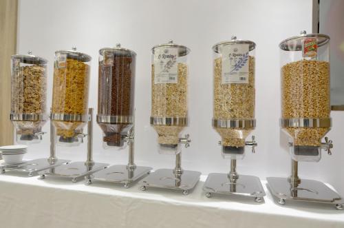 a group of different types of cereals in wine bottles at UVE Marcenado in Madrid