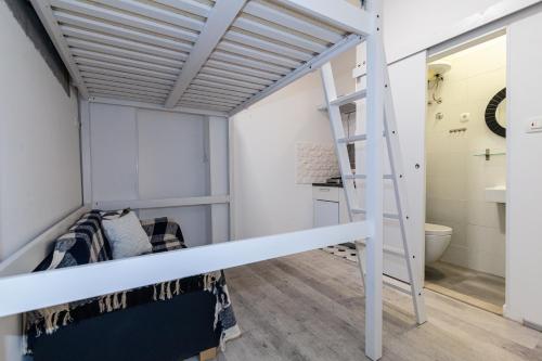 a bunk bed in a room with a ladder at Andriana House in Šibenik