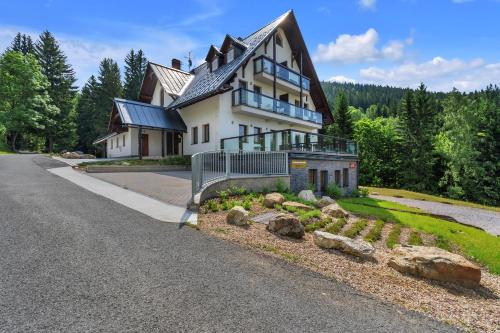 a large house on the side of a road at Rezidence Rokytnice in Rokytnice nad Jizerou