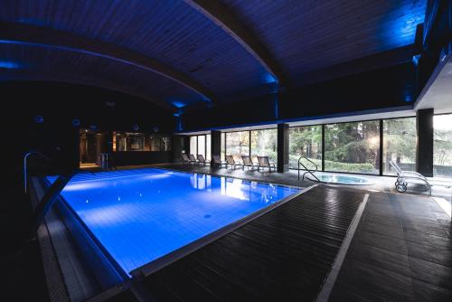 a swimming pool with blue lighting in a building at Balneario Font Vella- Adults Only in Sant Hilari Sacalm