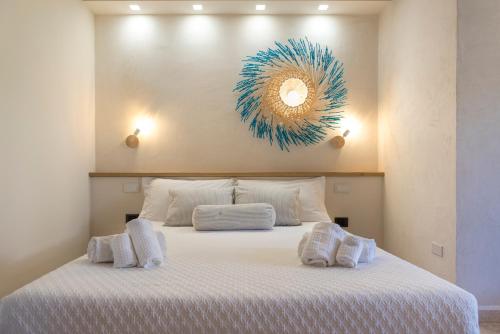 a bedroom with a bed with a mirror on the wall at Domo Pro Vois in Orosei