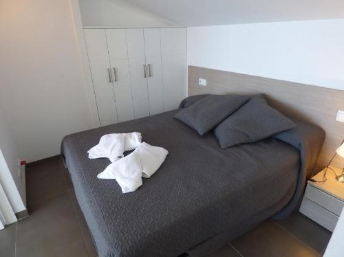 a bedroom with a bed with two towels on it at Voramar 33A - Joana Attic in Port de Pollensa