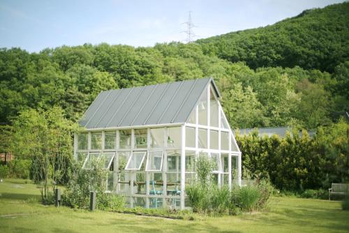 a house with a solar roof on a field at Eden Paradise Hotel in Icheon