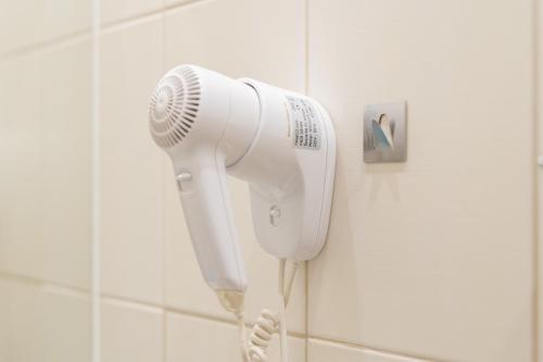 a hair dryer is attached to a wall in a bathroom at SeaPark Hotel Wellness & Spa in Kołobrzeg