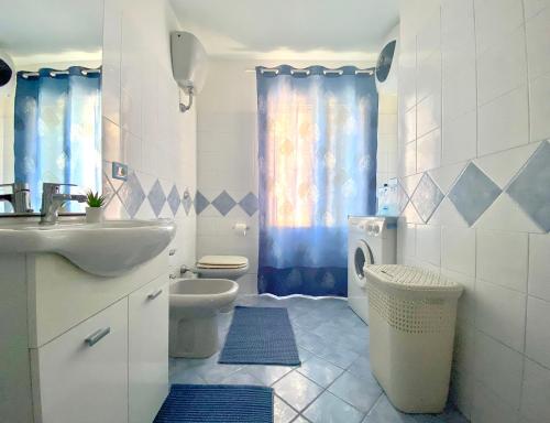 a bathroom with a sink and a toilet and a shower at Stella Marina in Santa Maria Navarrese