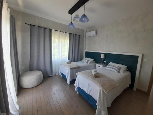 a hotel room with two beds and a window at Diogenis Villa in Argostoli