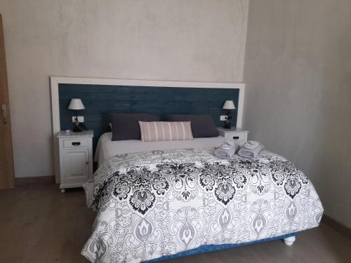 a bedroom with a large bed and two night stands at Diogenis Villa in Argostoli