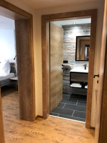 a bathroom with a sink and a mirror at Ferienhof Oberer Gollmitzer in Heiligenblut