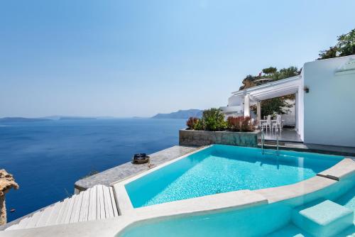 a swimming pool with a view of the water at Andronis Luxury Suites in Oia