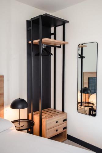a bedroom with two black lamps and a mirror at LATROUPE La Granja in Bilbao