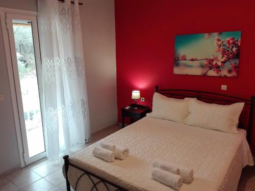a bedroom with a bed with two towels on it at Katerina's home in Moraitika