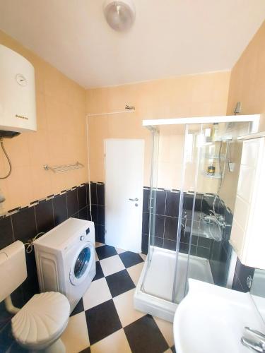 a bathroom with a toilet and a shower and a sink at Old Town Experience - Studio Apartment in Budva