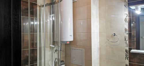 a bathroom with a shower and a water tank at Villa Lazuren Bryag in Chernomorets