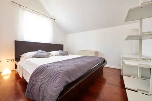 a bedroom with a large bed and a large window at Apartments Gea Trogir in Trogir