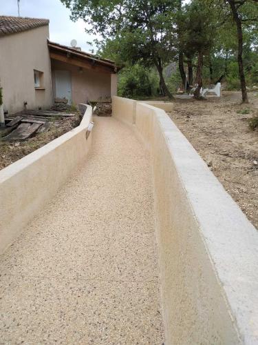 a concrete retaining wall next to a house at La Maison St Gervais in Saint-Gervais