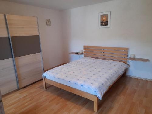 a small bedroom with a bed and a closet at Hiša Pepi in Ajdovščina
