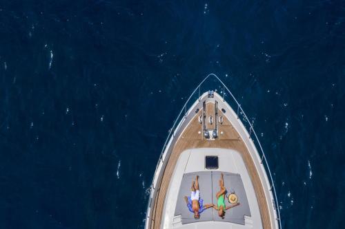 an aerial view of a boat in the ocean at Andronis Luxury Suites in Oia