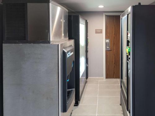 a kitchen with a refrigerator and a tile floor at Comfort Inn & Suites Wyomissing-Reading in Wyomissing