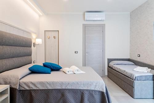 Postel nebo postele na pokoji v ubytování Versilia Residence - Colombo