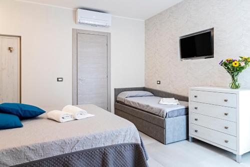 Postel nebo postele na pokoji v ubytování Versilia Residence - Colombo
