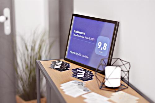 a computer monitor sitting on top of a table at Apartmány Ve stodole in Roudnice nad Labem