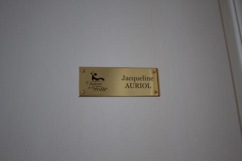 a sign on a white wall with a sign on it at Château de la Folie in Trie-Château