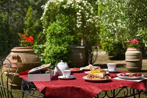 a table with plates of food on a red table cloth at B&B Villa Giulia in Saturnia