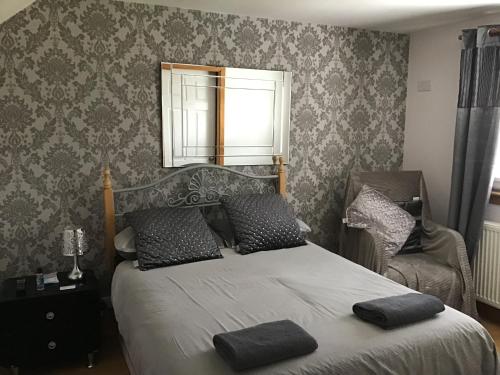 a bedroom with a bed with two pillows on it at No.9 in Inverness